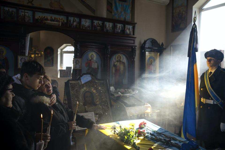 A mother and son grieve at the coffin of an Azov Assault Brigade soldier who died defending the Azovstal steel plant in Mariupol in April 2022 against the Russians. (AP Photo/Emilio Morenatti)