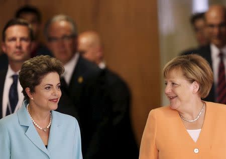 Germany's Chancellor Angela Merkel (R) and Brazil's President Dilma Rousseff talk after a meeting at the Planalto Palace in Brasilia, Brazil, August 20, 2015. REUTERS/Ueslei Marcelino
