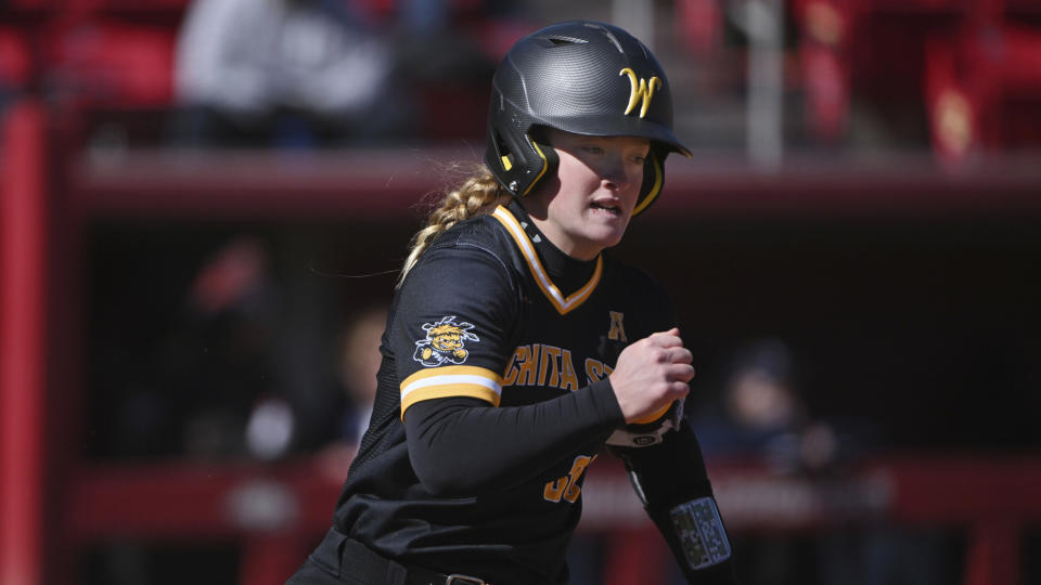 FILE - Wichita State batter Addison Barnard (30) runs to first base against Illinois during an NCAA softball game in Fayetteville, Ark., Feb. 18, 2022. (AP Photo/Michael Woods, File)