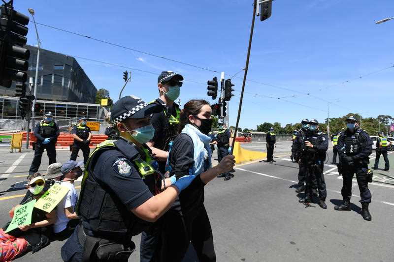 Police remove a protester from the road during an Extinction Rebellion protest in Melbourne.