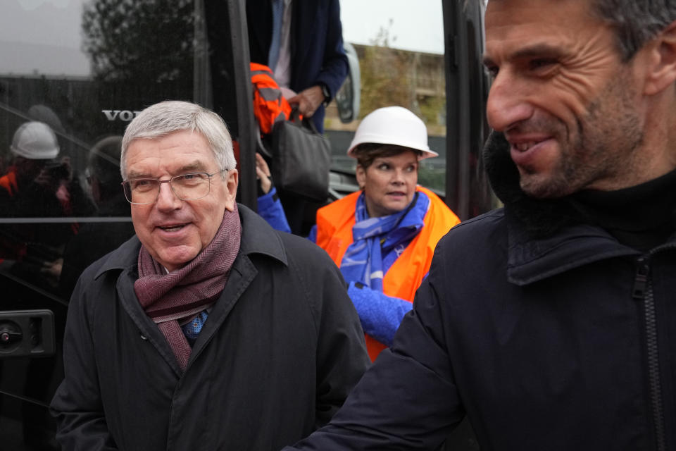 International Olympic Committee (IOC) president Thomas Bach, left, and Paris 2024 Olympics Organizing Committee President Tony Estanguet, right, arrive to visit the Olympic Village Friday, Dec. 1, 2023 in Saint-Denis, outside Paris. The Paris 2024 Olympic Games will run from July 26 to Aug.11, 2024. (AP Photo/Michel Euler)