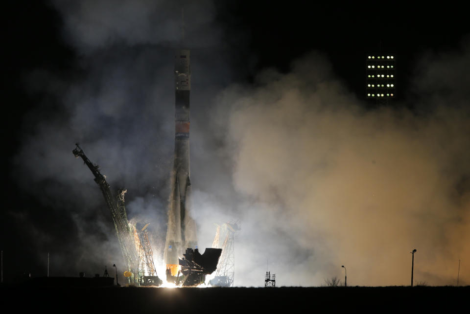 The Soyuz-FG rocket booster with Soyuz TMA-12M space ship carrying a new crew to the International Space Station (ISS) blasts off at the Russian leased Baikonur cosmodrome, Kazakhstan, Wednesday, March 26, 2014. The Russian rocket carries astronaut Steven Swanson, Russian cosmonauts Alexander Skvortsov and Oleg Artemyev. (AP Photo/Dmitry Lovetsky)