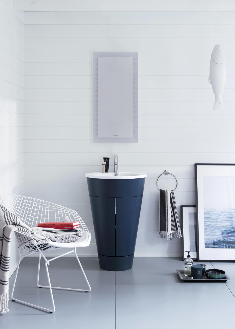 This photo shows Duravit's Starck 1 barrel vanity and is now available in an inky blue. The color and unique shape make it a standout piece in bathrooms of any size. (Duravit via AP)