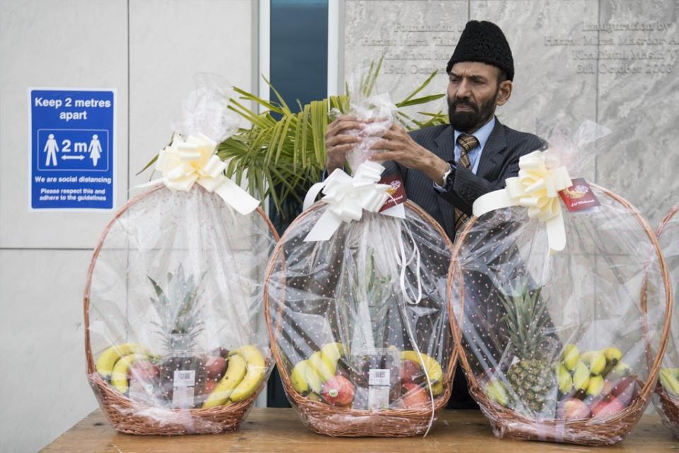 A volunteer prepares to give out fruit baskets to worshippers at the Baitul Futuh Mosque in Morden, south London, ahead of Eid al-Fitr last year (Kirsty O’Connor/PA) (PA Archive)