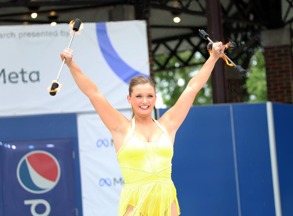 Grace Wood, 20, of Indianola performs twirling routine with fire in the Senior division  during the 62nd Bill Riley Talent Search finals on the Anne and Bill Riley Stage at the Iowa State Fair on Sunday, August 21, 2022, in Des Moines.