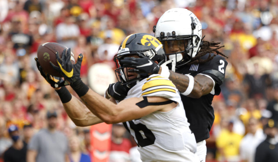Iowa's Charlie Jones catches a touchdown pass as Iowa State's Datrone Young tries to defend in the second half during an NCAA football game on Saturday, Sept. 11, 2021, in Ames, Iowa. (AP Photo/Justin Hayworth)