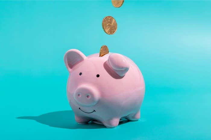 coins falling into a piggy bank