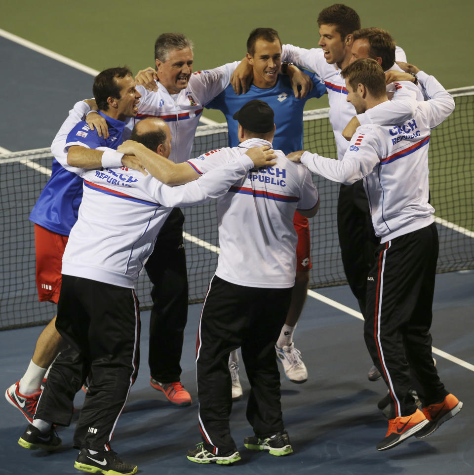 Lukas Rosol, center top, Radek Stepanek, left and other team members of the Czech Republic celebrate after defeating Japan during quarterfinal of Davis Cup World Group tennis at Ariake Colosseum in Tokyo, Saturday, April 5, 2014. (AP Photo/Koji Sasahara)