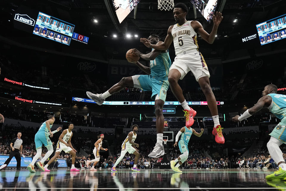 Charlotte Hornets center Nathan Mensah (31) vies for the ball with New Orleans Pelicans forward Herbert Jones (5) during the first half of an NBA basketball game Friday, Dec. 15, 2023, in Charlotte, N.C. (AP Photo/Chris Carlson)