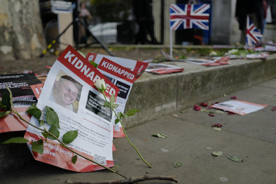 FILE - Posters with the faces and names of people believed to be taken hostage by Hamas, are left outside Downing Street by people attending a vigil in support of Israel in London, on Nov. 7, 2023. (AP Photo/Alberto Pezzali, File)