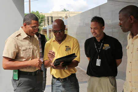 Jamaica's Prime Minister Andrew Holness meets with E.G. Hunter, Parris Lyew-Ayee and Varden Downer from the National Works Agency, as Jamaicans brace on Saturday for the arrival of Hurricane Matthew in Kingston, Jamaica, October 1, 2016. REUTERS/Gilbert Bellamy