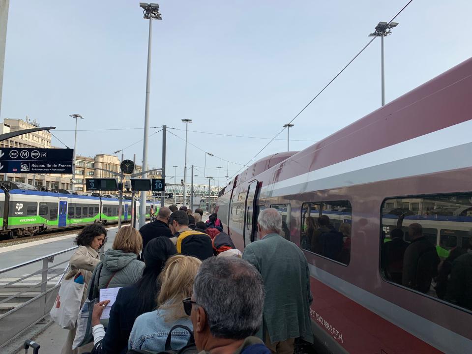 people boarding a train at gare du nord station in paris