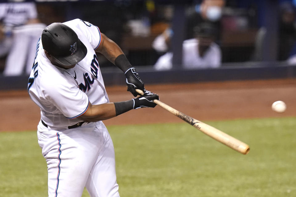 Miami Marlins' Jesus Aguilar hits a RBI-single to score Miguel Rojas during the eighth inning of a baseball game Arizona Diamondbacks, Tuesday, May 4, 2021, in Miami. The Marlins won 9-3. (AP Photo/Lynne Sladky)