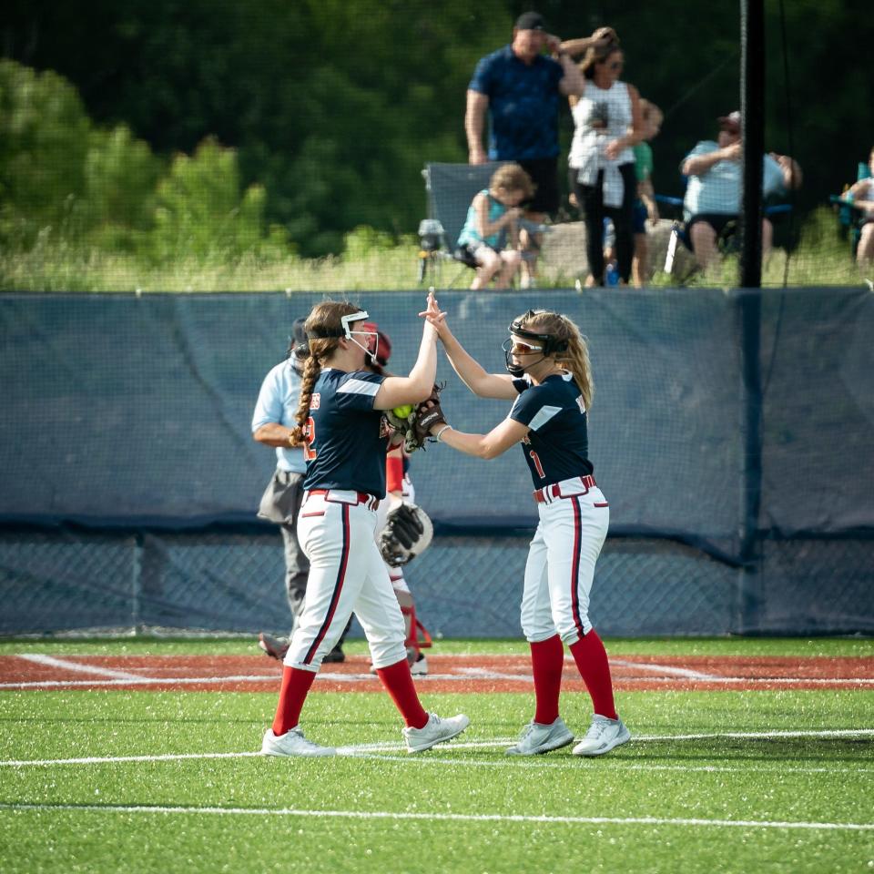 From left, Sienna Holmes and Taylor Raux hype each other up before an inning during their semifinal win against East Syracuse-Minoa at Accelerate Sports Complex in Whitesboro on Thursday, May 26, 2022. New Hartford won 3-0 and will play No. 1 Jamesville-Dewitt (18-3) at 11 a.m. on May 28.