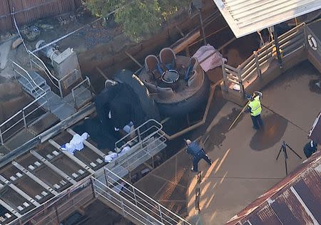 Emergency services personnel can be seen near a ride inside the Dreamworld theme park at Coomera on the Gold Coast, Australia, October 25, 2016 after a number of people were reported killed on a ride at Australia's biggest theme park. AAP/Dan Peled/via REUTERS