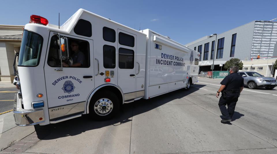 A Denver Police Department incident command unit is pulled into a parking lot near the scene of a triple homicide south of downtown Denver, Thursday, Aug. 9, 2018. Police are trying to determine if the deaths of three homeless people are related to an earlier stabbing in the area. (AP Photo/David Zalubowski)