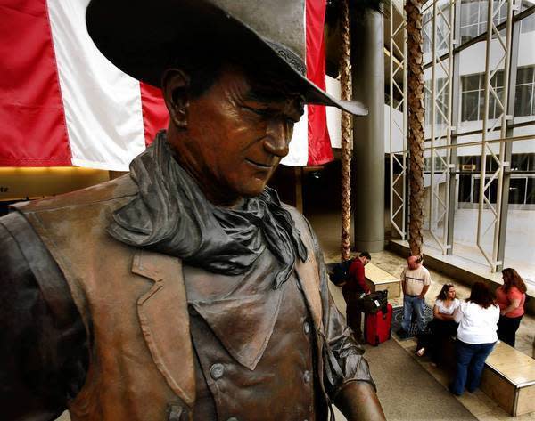 A 9-foot bronze statue of John Wayne greets passengers at John Wayne Airport in Orange County. Fewer namesakes remain in Newport Beach, the city where the screen legend spent his final years.