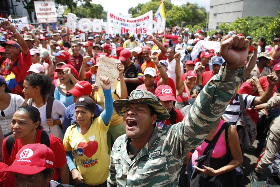 A member of the Bolivarian militia shouts during a protest against a report by Michelle Bachelet, U.N. high commissioner for human rights, in Caracas, Venezuela, Saturday, July 13, 2019. Bachelet recently published a report accusing Venezuelan officials of human rights abuses, including extrajudicial killings and measures to erode democratic institutions. (AP Photo/Leonardo Fernandez)