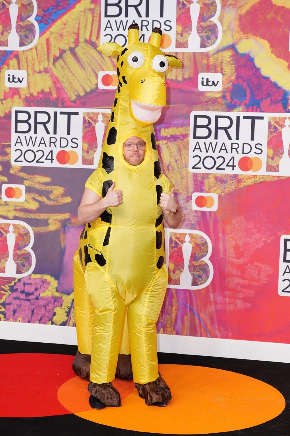 Rob Beckett stood head and shoulders (literally) above the other attendees in a giraffe costume (PA)