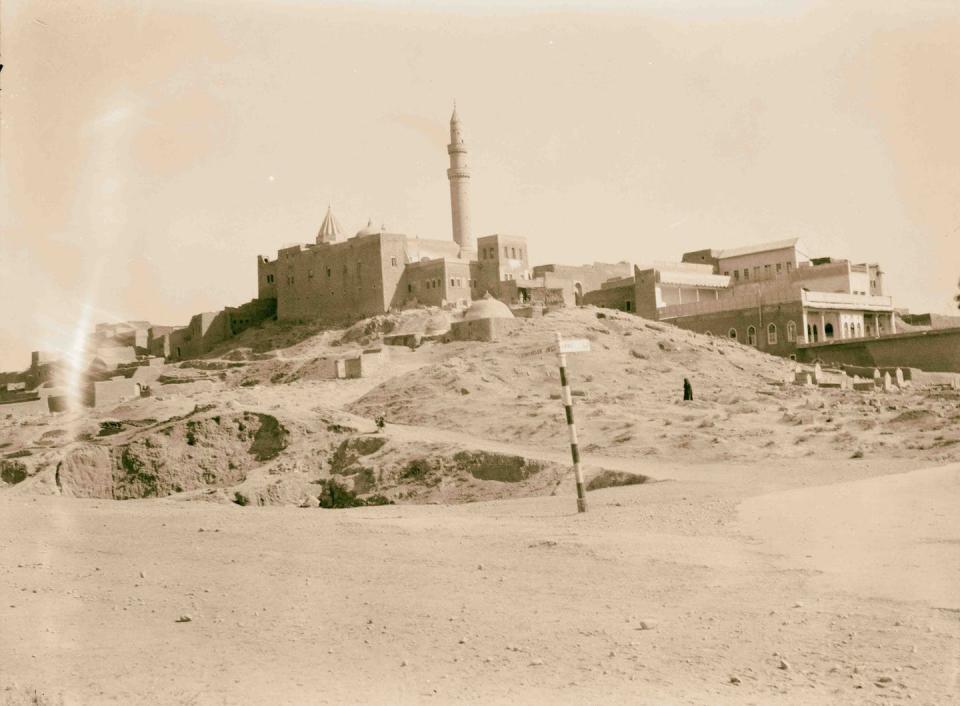 Black-and-white picture of an ancient building with a tower