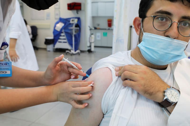 FILE PHOTO: An Israeli man receives his third dose of the coronavirus disease (COVID-19) vaccine, in Beit Shemesh