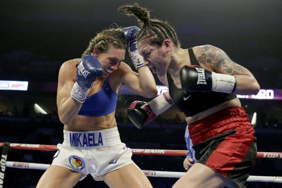 Mikaela Mayer, left, and Vanessa Bradford exchange blows during their super featherweight NABF title boxing bout in Omaha, Neb., Saturday, Oct. 13, 2018. Mikaela Mayer won by unanimous decision. (AP Photo/Nati Harnik)
