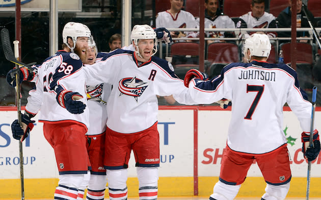 GLENDALE, AZ - DECEMBER 03: Boone Jenner #38 of the Columbus Blue Jackets celebrates with teammates David Savard #58 and Jack Johnson #7 after his first period goal against the Arizona Coyotes at Gila River Arena on December 3, 2016 in Glendale, Arizona. (Photo by Norm Hall/NHLI via Getty Images)