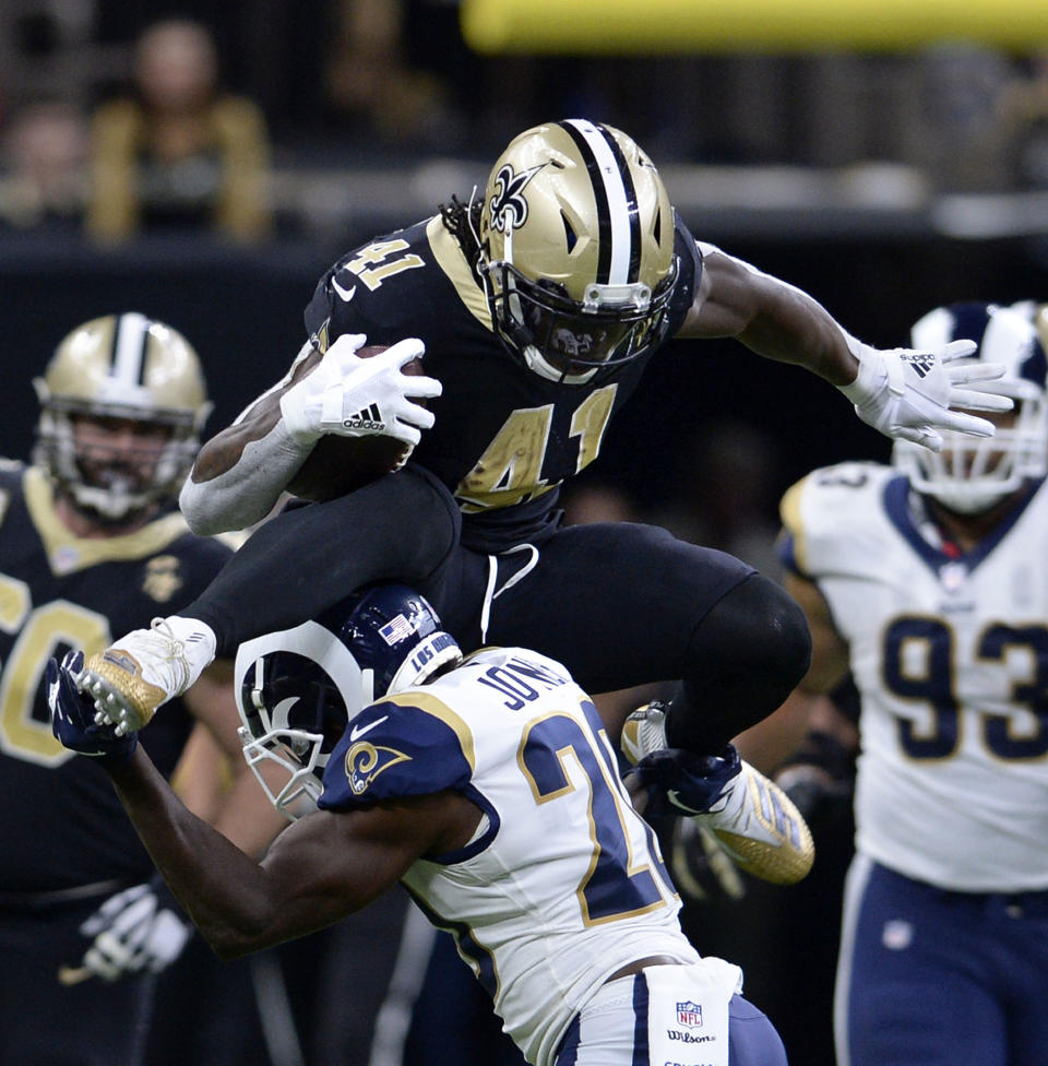 New Orleans Saints running back Alvin Kamara (41) leaps over Los Angeles Rams free safety Lamarcus Joyner (20) on a rushing play in the second half of an NFL football game in New Orleans, Sunday, Nov. 4, 2018. (AP Photo/Bill Feig)