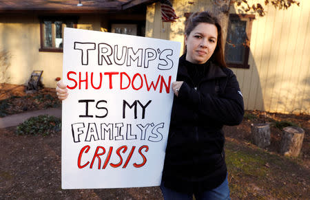 Cher Muzyk, wife of a government attorney impacted by the shutdown, holds the sign she carried at yesterdays DC "Rally to End the Shutdown" at her home in Nokesville, Virginia, U.S., January 11, 2019. REUTERS/Kevin Lamarque/Files