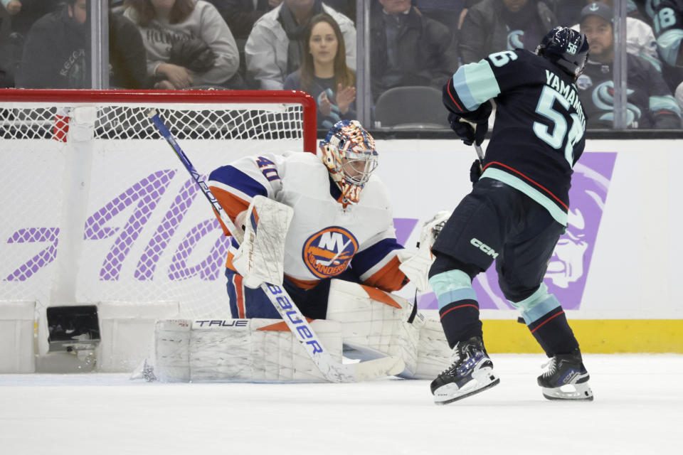 Seattle Kraken right wing Kailer Yamamoto (56) scores past New York Islanders goaltender Semyon Varlamov (40) in the shootout of an NHL hockey game, Thursday, Nov. 16, 2023, in Seattle. (AP Photo/John Froschauer)