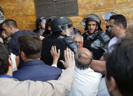 Protesters entered Macedonia's parliament after the governing Social Democrats and ethnic Albanian parties voted to elect an Albanian as parliament speaker in Skopje. Macedonia April 27, 2017. REUTERS/Ognen Teofilovski