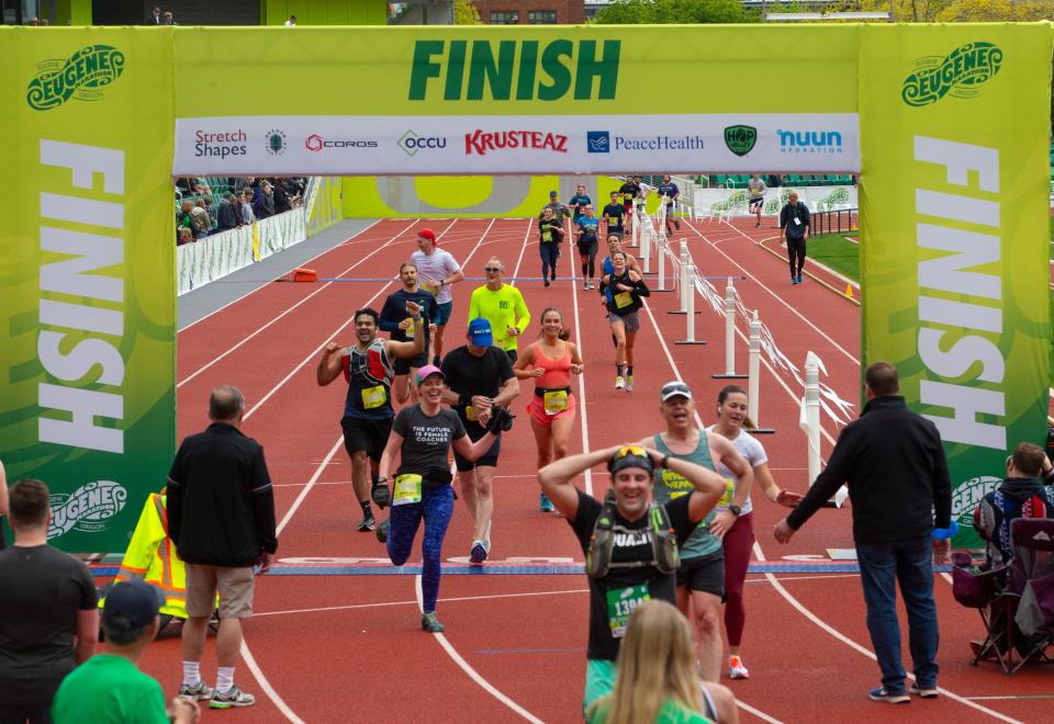 Runners finish their half marathon on the track at Hayward Field during the 2022 Eugene Marathon in Eugene Sunday in May 2022.