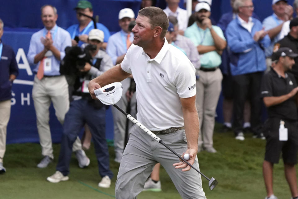 Lucas Glover celebrates after his putt on the 18th hole to win the Wyndham Championship golf tournament in Greensboro, N.C., Sunday, Aug. 6, 2023. (AP Photo/Chuck Burton)