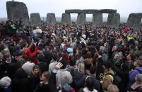 Crowds gather at dawn amongst the stones at Stonehenge in Wiltshire for the Summer Solstice.