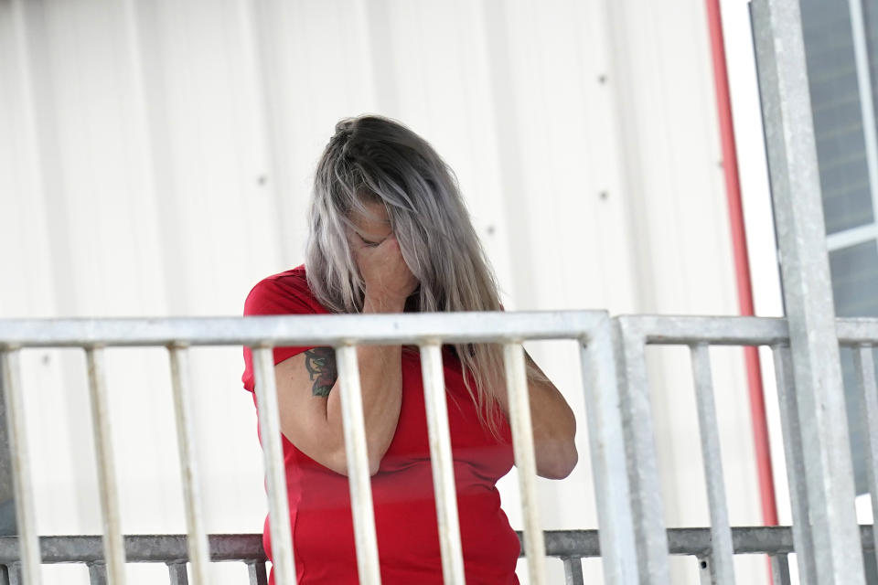 Marion Cuyler, fiancée of missing crew member Chaz Morales, talks on her cell phone at a fire station where family members of 12 people missing from a capsized oil industry vessel have been gathering, Thursday, April 15, 2021, in Port Fourchon, La. The lift boat capsized in the Gulf of Mexico during a storm on Tuesday, killing one with 12 others still missing. (AP Photo/Gerald Herbert)