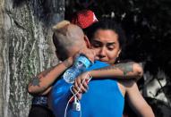 <p>Friends and family members embrace outside the Orlando Police Headquarters during the investigation of a shooting at the Pulse nightclub, where people were killed by a gunman, in Orlando, June 12, 2016. (REUTERS/Steve Nesius) </p>