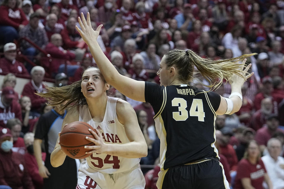 Indiana's Mackenzie Holmes (54) looks to shoot against Purdue's Caitlyn Harper (34) during the second half of an NCAA college basketball game, Sunday, Feb. 19, 2023, in Bloomington, Ind. (AP Photo/Darron Cummings)