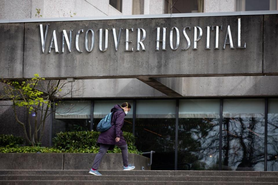 People in masks walk towards Vancouver General Hospital in Vancouver on Friday, April 24, 2020. (Maggie MacPherson/CBC)