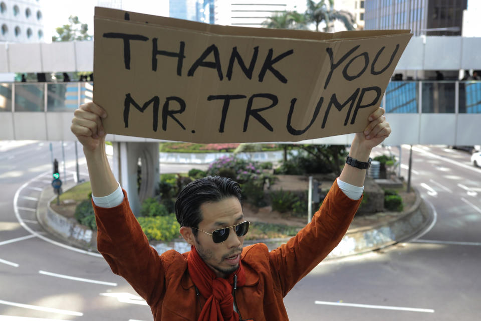 A man holds a placard during a lunchtime protest in Hong Kong, China, November 28, 2019. REUTERS/Marko Djurica