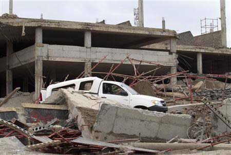 A view of a building that collapsed is seen in the South African town of Tongaat, about 45 km (28 miles) north of Durban, November 20, 2013. REUTERS/Rogan Ward