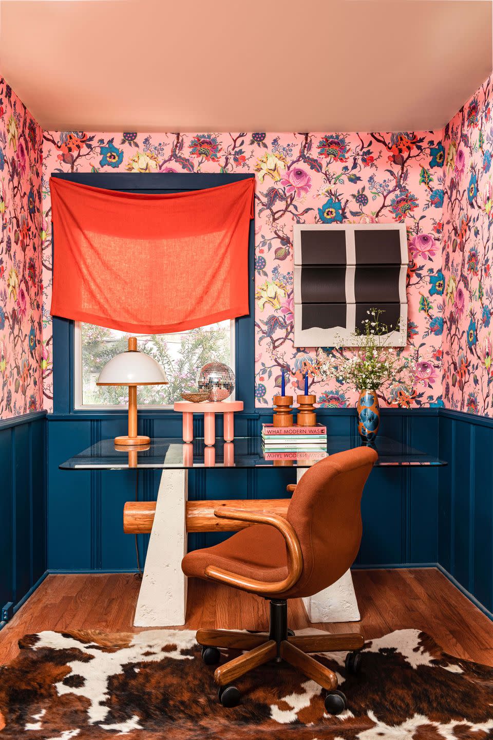 office with glass desk and pink botanical wallpaper