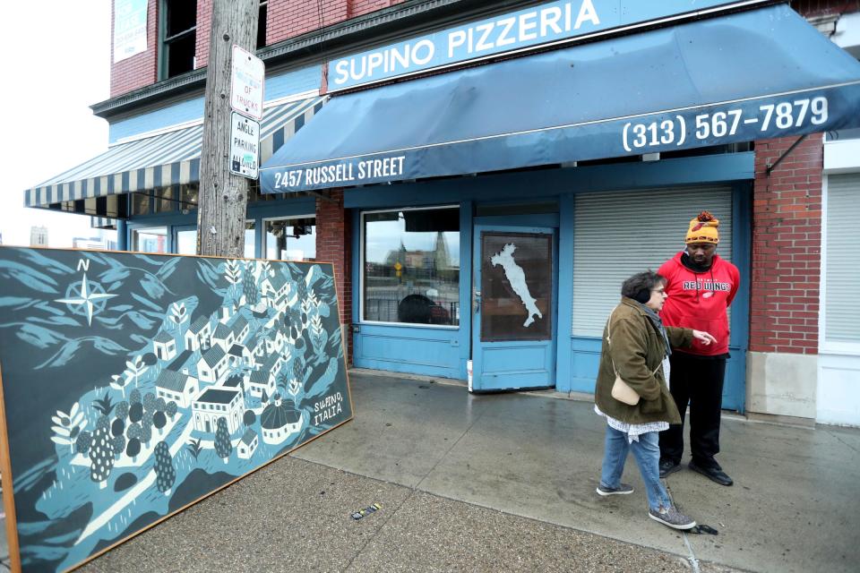 The Detroit fire department put out flames above Supino Pizzeria located in Eastern Market Monday, April 24, 2023. Supino and Zeffs Coney Island sustained water damage while the upper lofts where the fire started were badly damaged. Linda Yellin and employee Rashad McCall outside after they saved a painting of the town of Supino, Italy the restaurant's namesake, from the dripping water after fire crews left the scene.