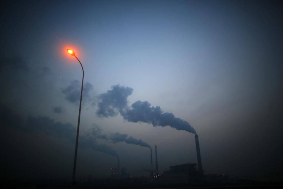 Smoke rises from chimneys of a thermal power plant near Shanghai March 26, 2014. China's energy-hungry, high-polluting industries continued to grow too fast in 2013, putting "huge pressures" on the environment and causing air quality to worsen, the country's pollution agency said on Tuesday. Premier Li Keqiang "declared war" on pollution in a major policy address this month, but China has long struggled to strike a balance between protecting the environment and keeping up economic growth. REUTERS/Carlos Barria (CHINA - Tags: BUSINESS ENVIRONMENT SOCIETY POLITICS)