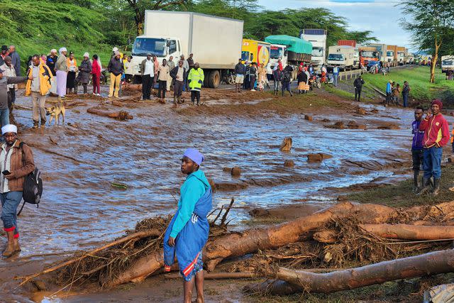 <p>AP Photo</p> People gathering after a dam burst in Kenya