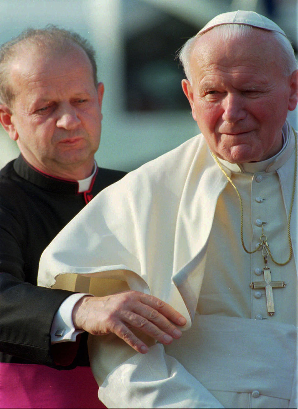 FILE - In this May 4, 1996 file photo, Pope John Paul II, right, is helped by his personal secretary, Stanislaw Dziwisz, as he arrives in Como, northern Italy, for a two day visit. Poles are divided between praise and condemnation of Pope John Paul II’s secretary over publishing the beloved pontiff’s personal notes against his last will and testament. John Paul ordered the notes burned after his death and put his trusted confidant, Dziwisz, in charge of the task. To everyone’s surprise, Dziwisz, now a cardinal, said recently that he “did not have the courage” to destroy the notes and is having them published as a precious insight into the inner life of the pope. (AP Photo/Luca Bruno, File)