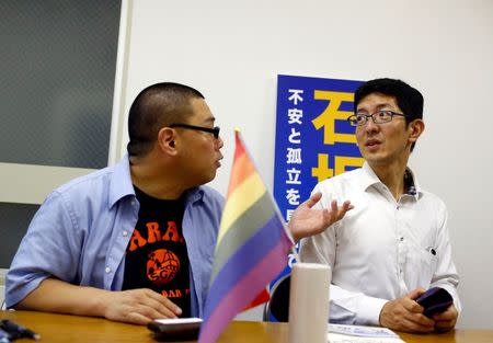 Local politician and LGBT activist Wataru Ishizaka (R) and his partner Yasunobu Akasugi talk in Ishizaka's office in Tokyo, Japan, June 22, 2016. REUTERS/Thomas Peter