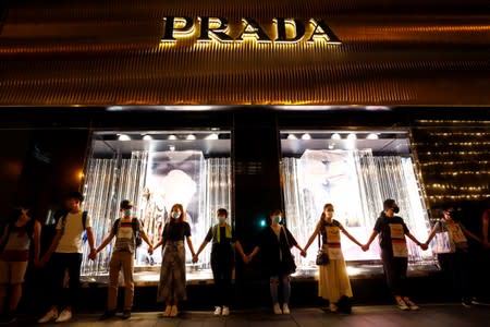 Protesters hold hands to form a human chain during a rally to call for political reforms in Hong Kong's Central district