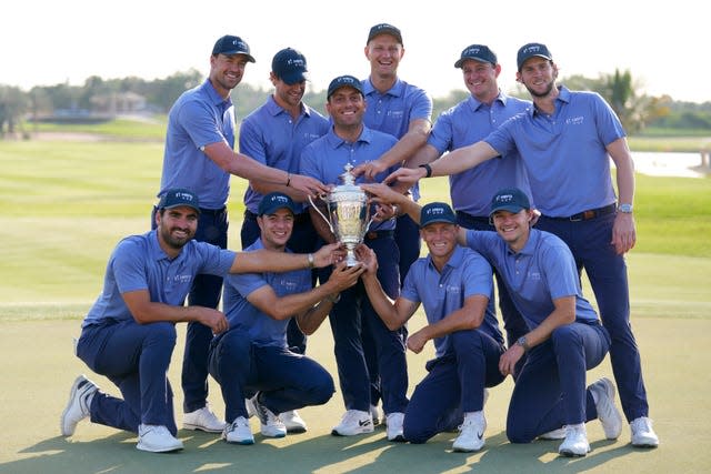 Francesco Molinari, the captain of Continental Europe, holds the trophy after victory over Great Britain and Ireland to win the Hero Cup in Abu Dhabi, (Kamran Jebreili/AP).