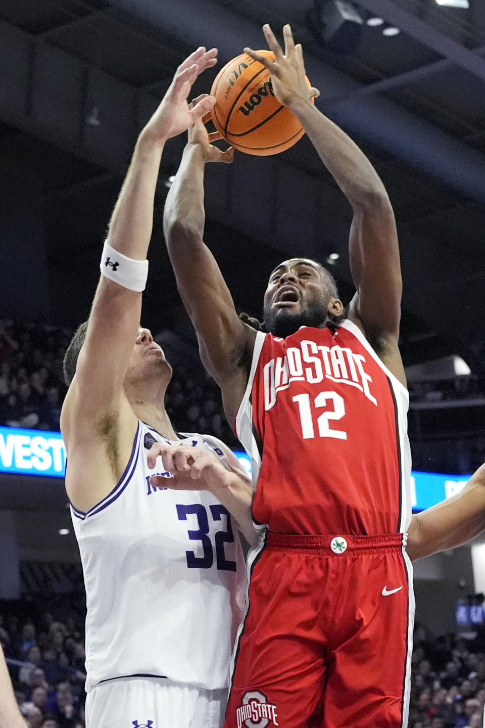 Ohio State guard Evan Mahaffey, right, battles for a rebound against Northwestern forward Blake Preston, left, during the first half of an NCAA college basketball game in Evanston, Ill., Saturday, Jan. 27, 2024. (AP Photo/Nam Y. Huh)