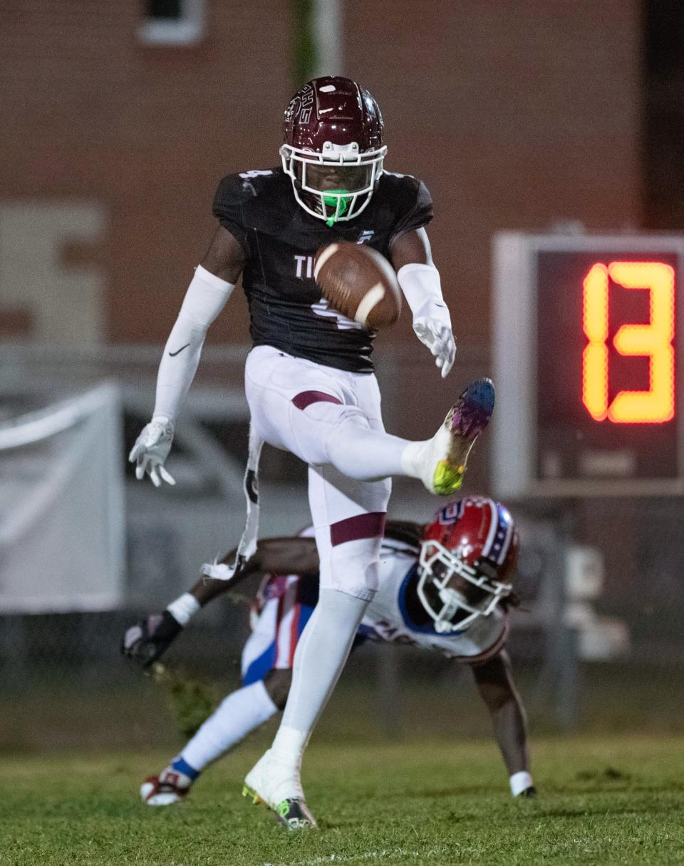 DeQuan Gaddy (4) gets off the punt under pressure in the end zone during the Pace vs PHS football game at Pensacola High School on Thursday, Oct. 5, 2023.